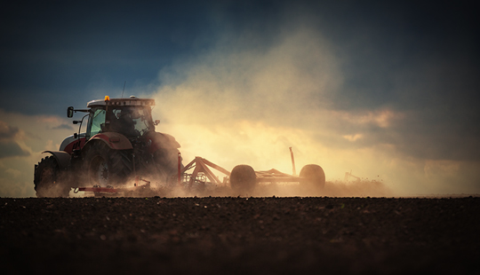 tractor ploughing field for reseeding