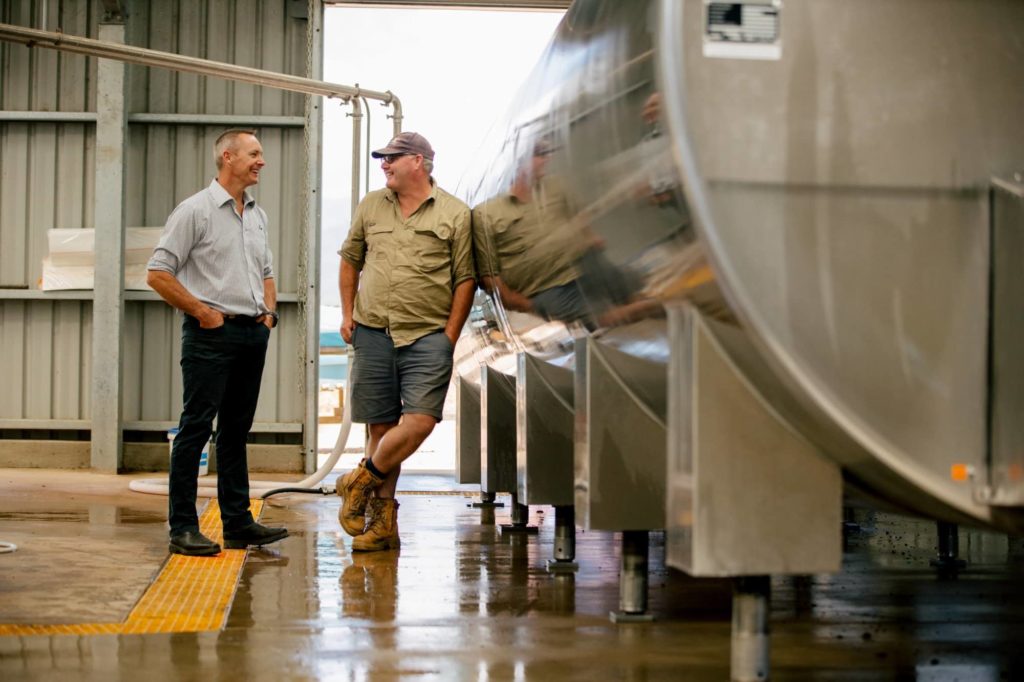 LIC consulting chatting to a dairy farmer